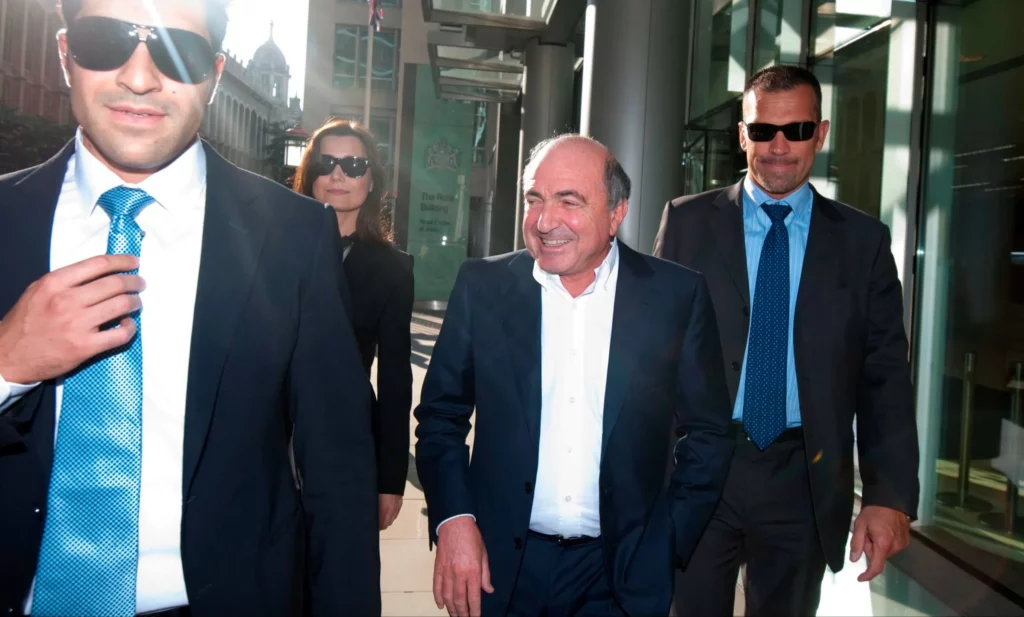  Russian billionaire Boris Berezovsky leaving London’s High Court with his bodyguards and then girlfriend Yelena Gorbunova in October 2011