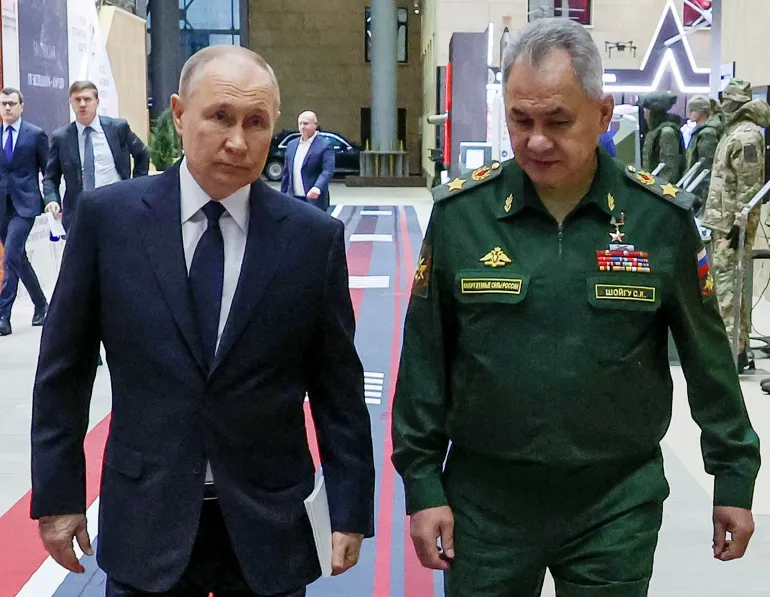 Russian President Vladimir Putin and Defence Minister Sergei Shoigu expressed optimism regarding Moscow's prospects of achieving its goals in Ukraine. The photograph captures a moment of discussion between the two leaders, highlighting the strategic confidence they project in their assessment of the ongoing military developments.